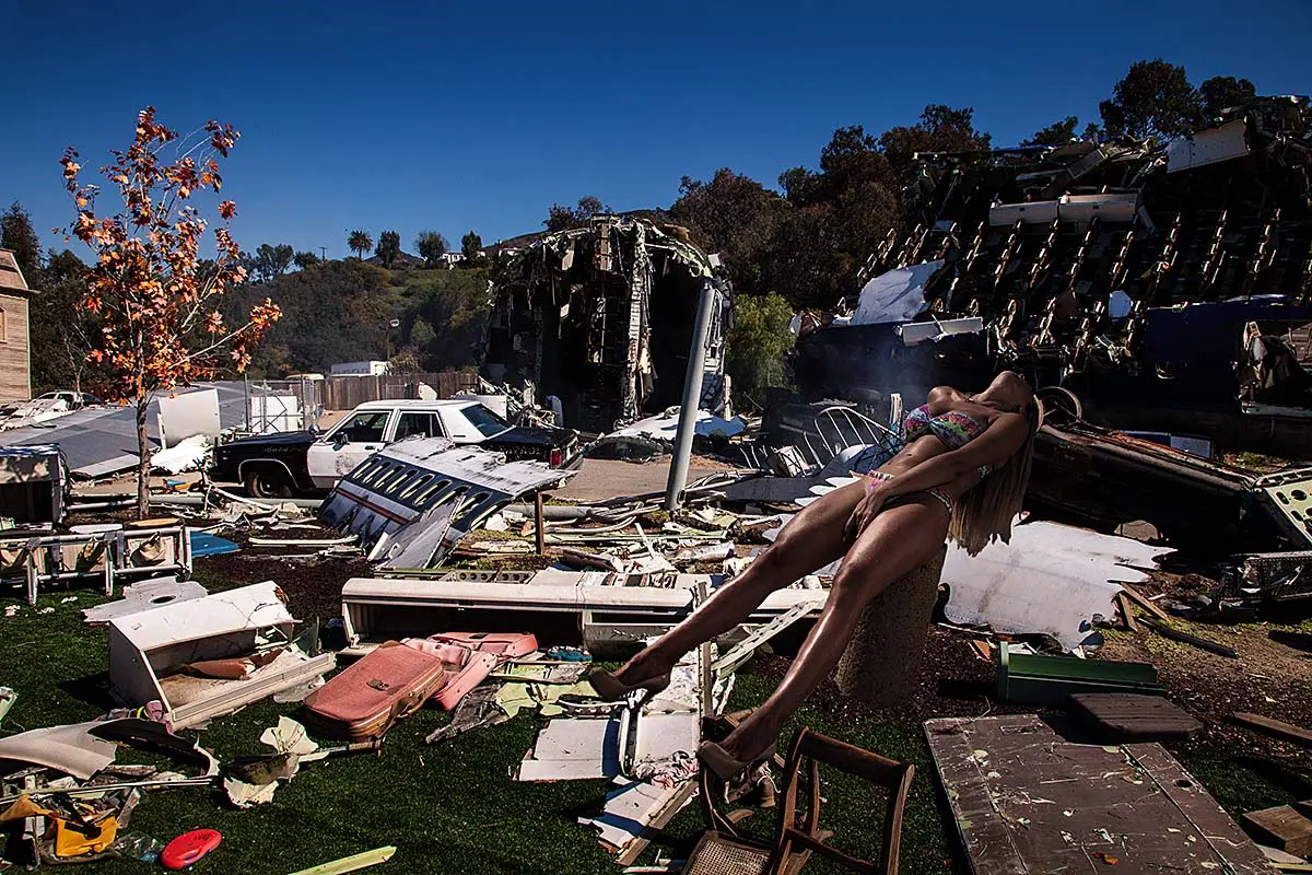 Sculpture amid scattered debris under bright blue sky, surreal art exhibition in Mykonos, Greece