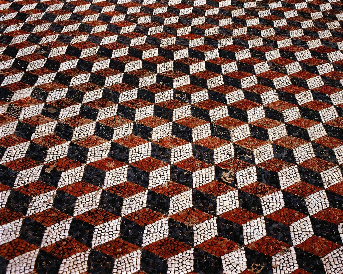 Geometric mosaic floor in red, black and white cubes, art exhibition in Mykonos, Greece
