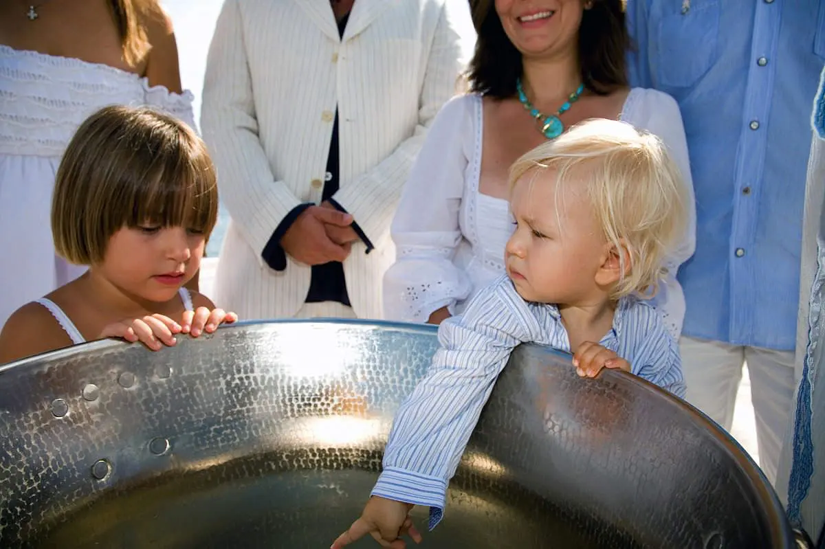 Tender baptism portrait of child after the ceremony in Mykonos, Greece
