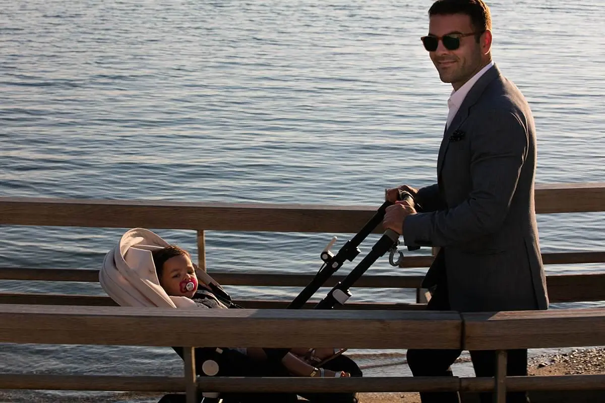 Coastal family stroll baptism portrait by Mykonos sea in Greece