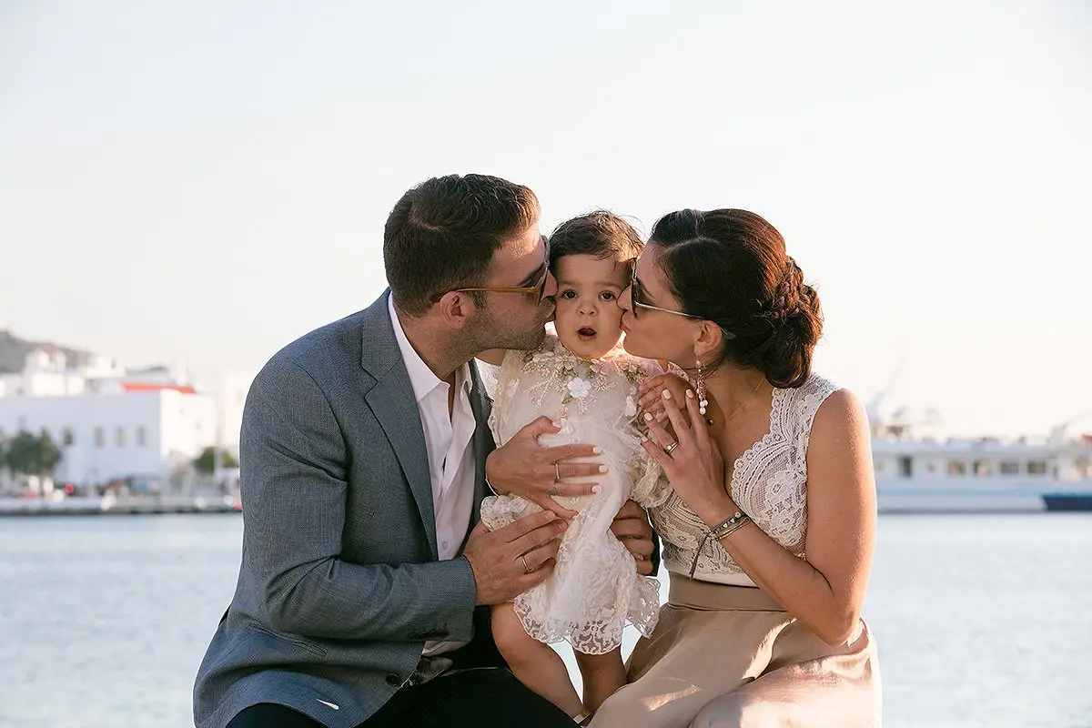 Natural-light infant baptism portrait with soft toy in Mykonos, Greece