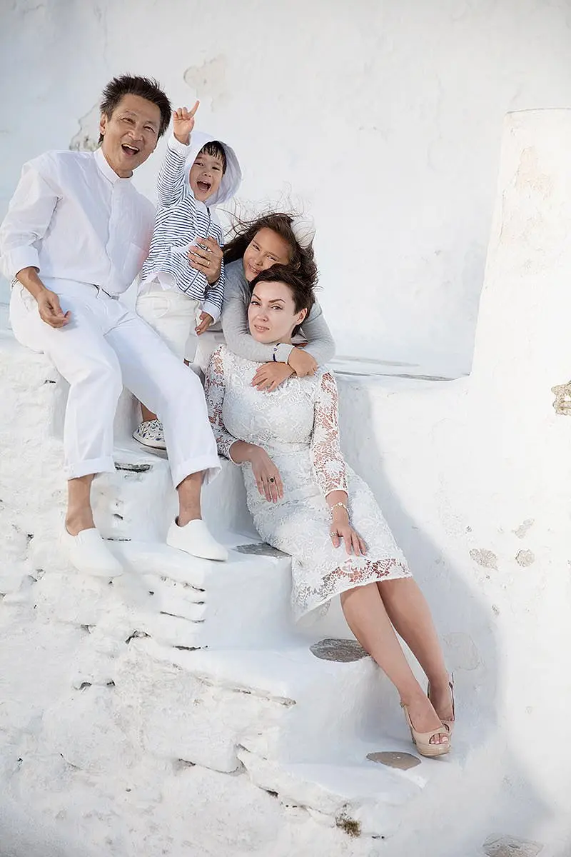 Cycladic-style family baptism portrait on Mykonos steps in Greece