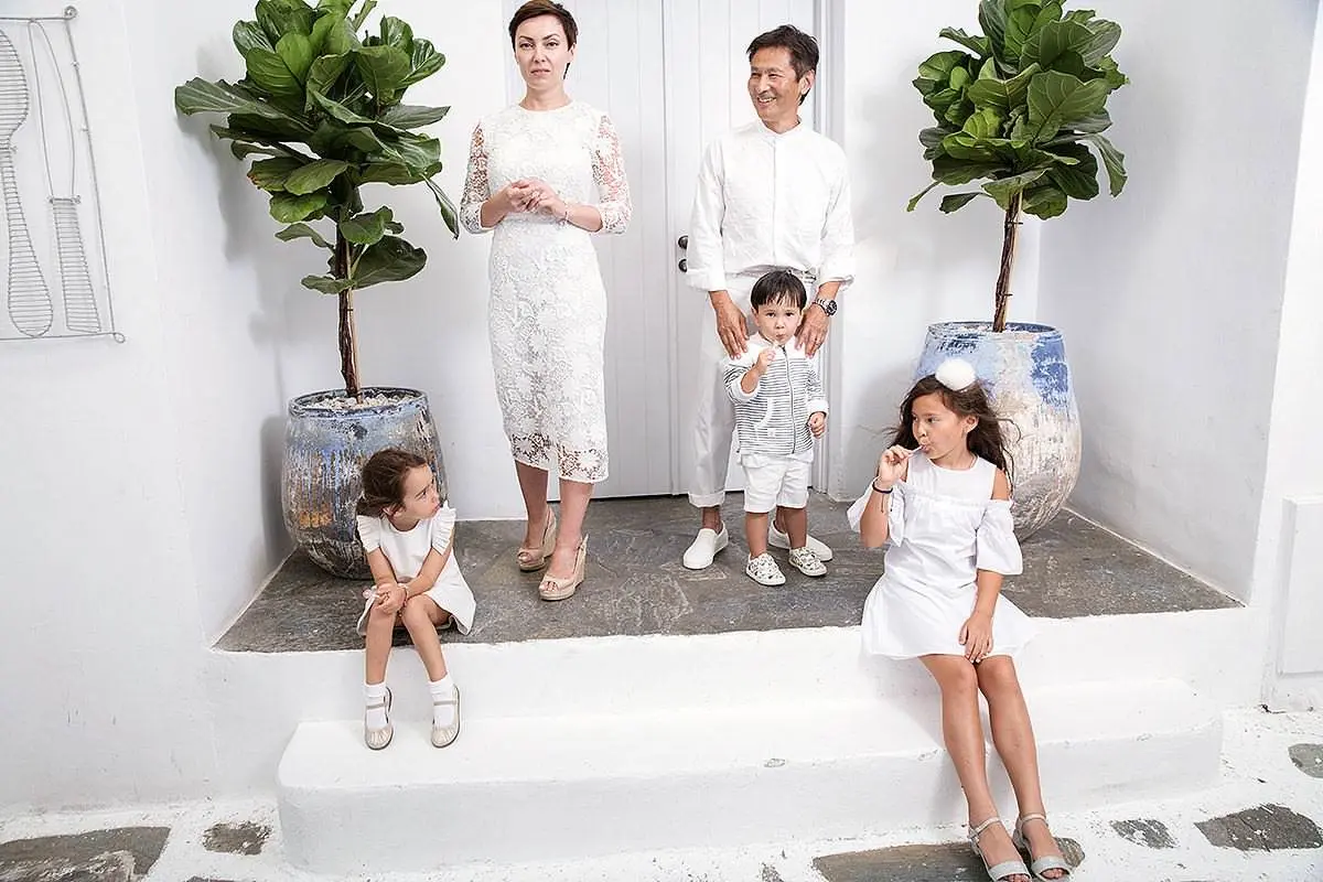 Whitewashed Mykonos chapel baptism portrait in Greece