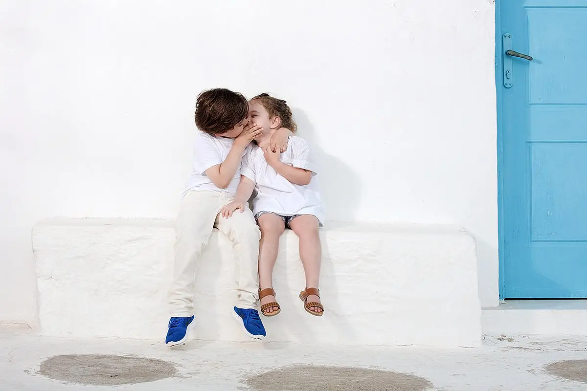 Mykonos lane baptism portrait against whitewashed walls in Greece