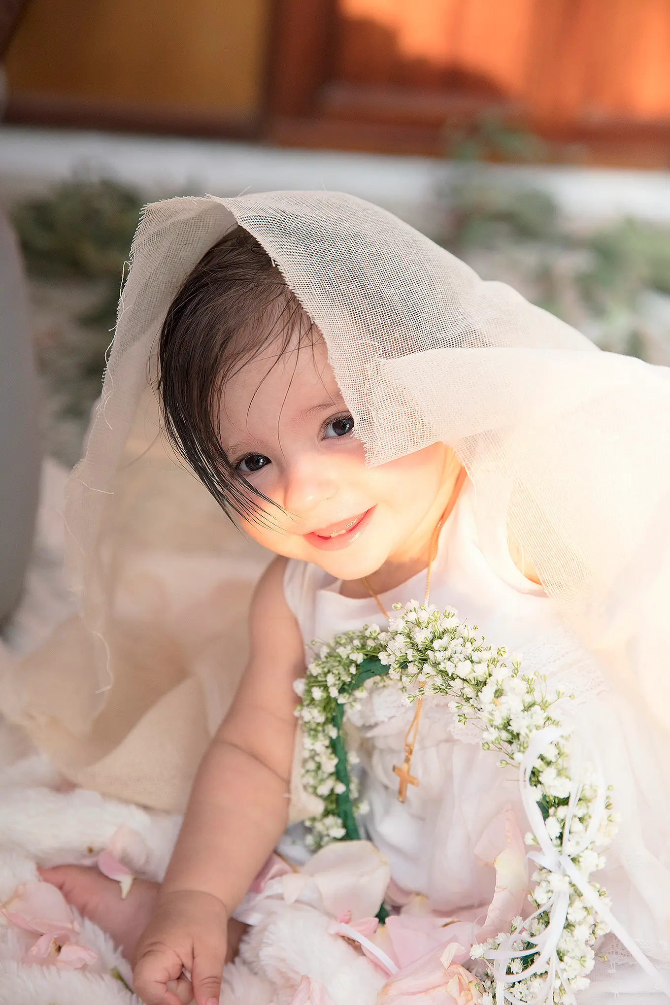 Greek Orthodox baptism portrait with floral cross and veil in Mykonos, Greece