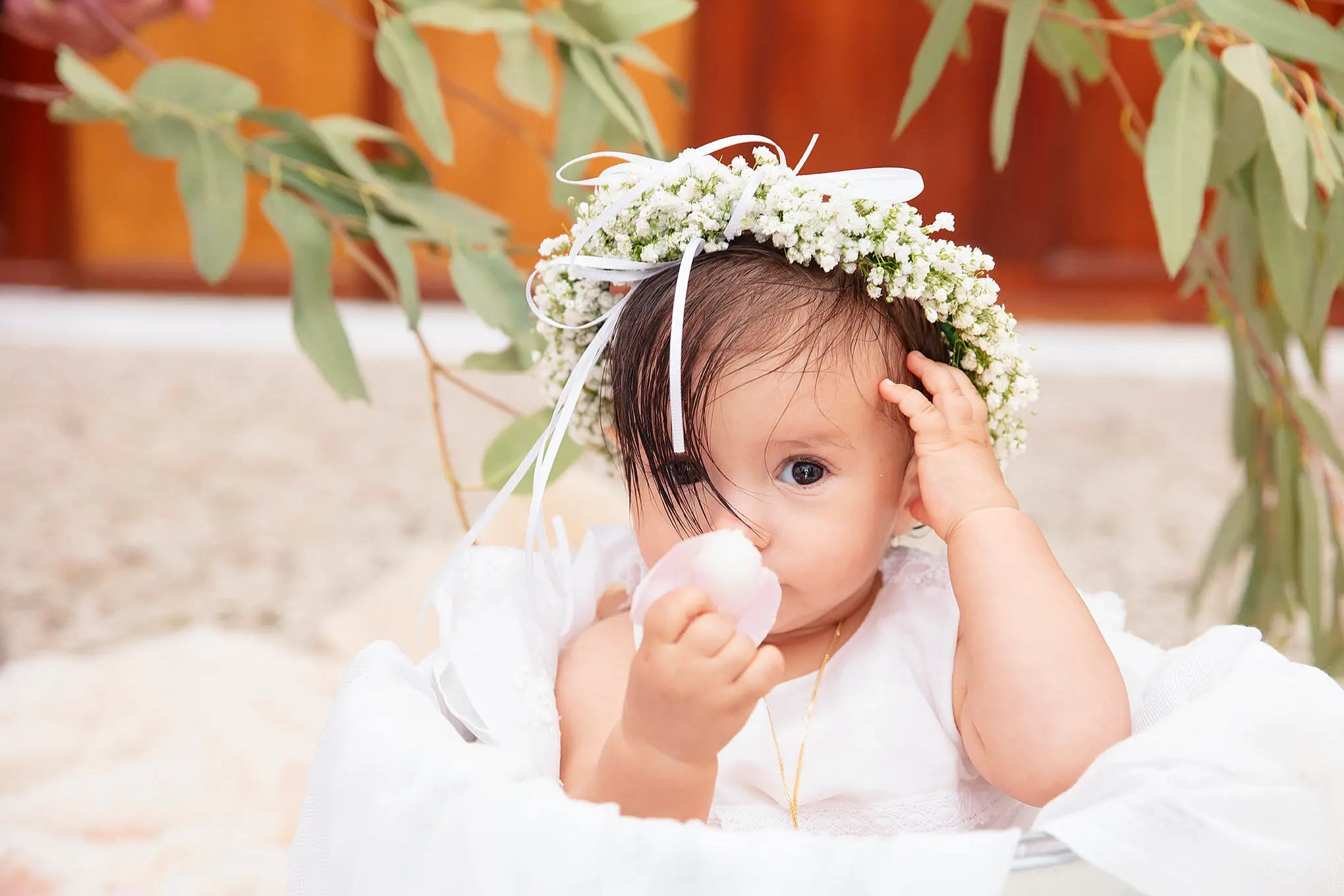 Soft baptism portrait with floral crown and eucalyptus in Mykonos, Greece