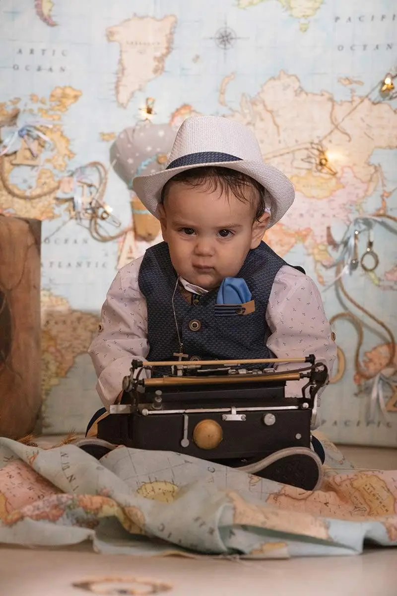 Themed travel studio baptism portrait with vintage map in Mykonos, Greece