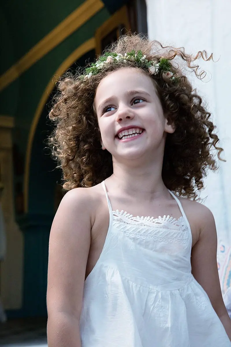 Warm-light tender baptism portrait in Mykonos, Greece