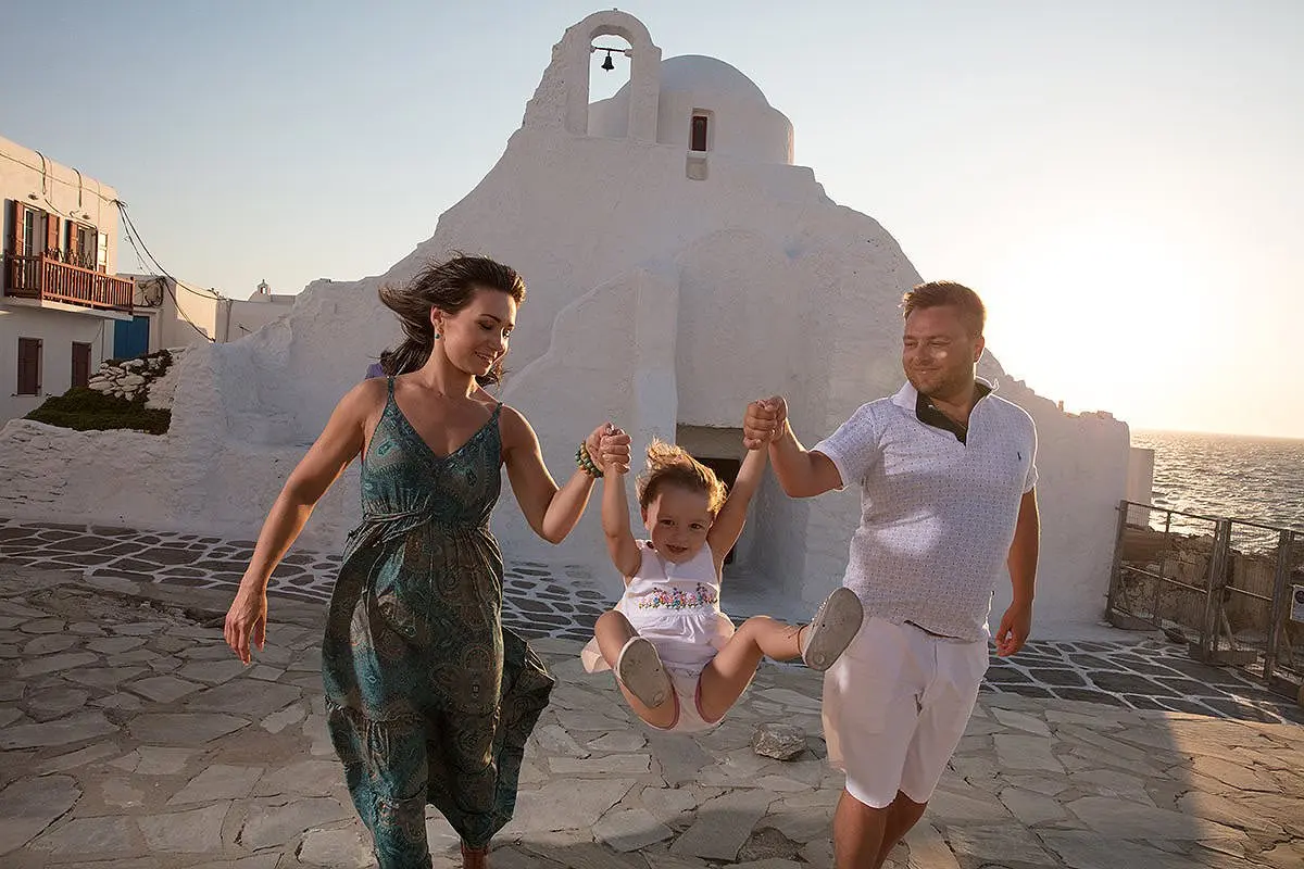 Sunset children portrait against Aegean sky in Mykonos, Greece