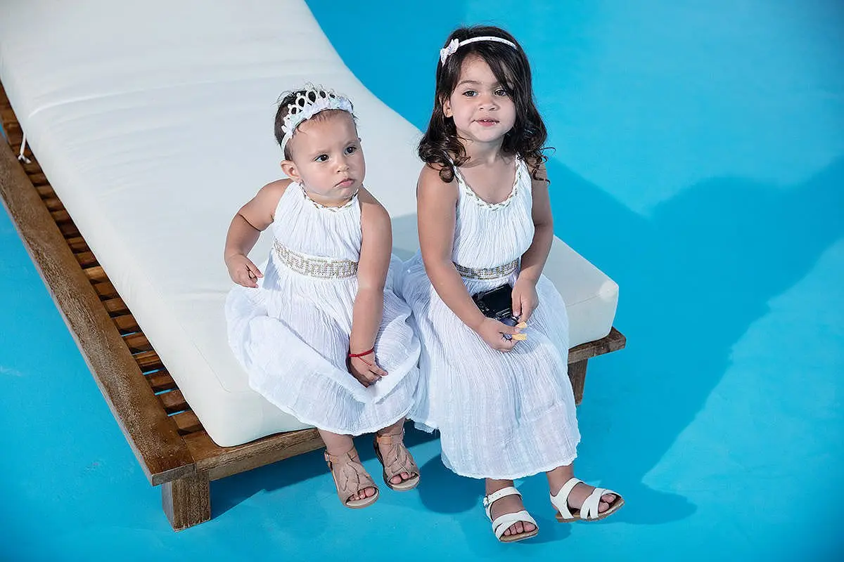 Poolside children portrait in white at Mykonos villa in Greece
