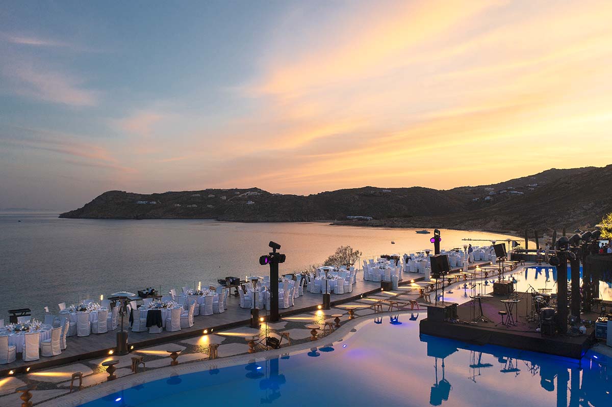 Aerial drone view of luxury wedding setup at Mykonos sunset, Greece