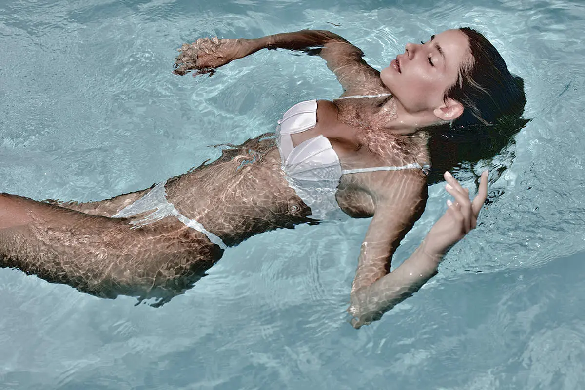 Male model relaxing poolside menswear fashion editorial in Mykonos, Greece