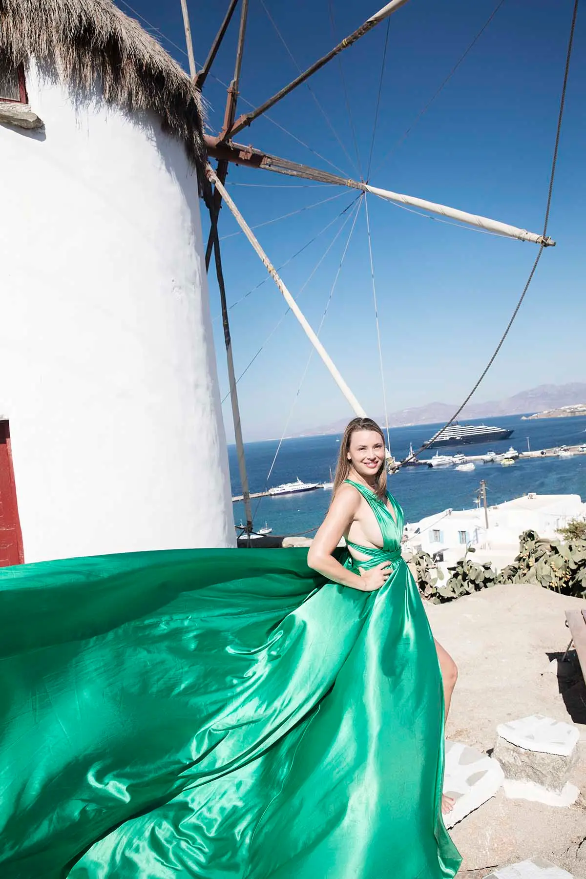 Sunlit amber flying dress on a Mykonos rooftop, photography in Mykonos, Greece
