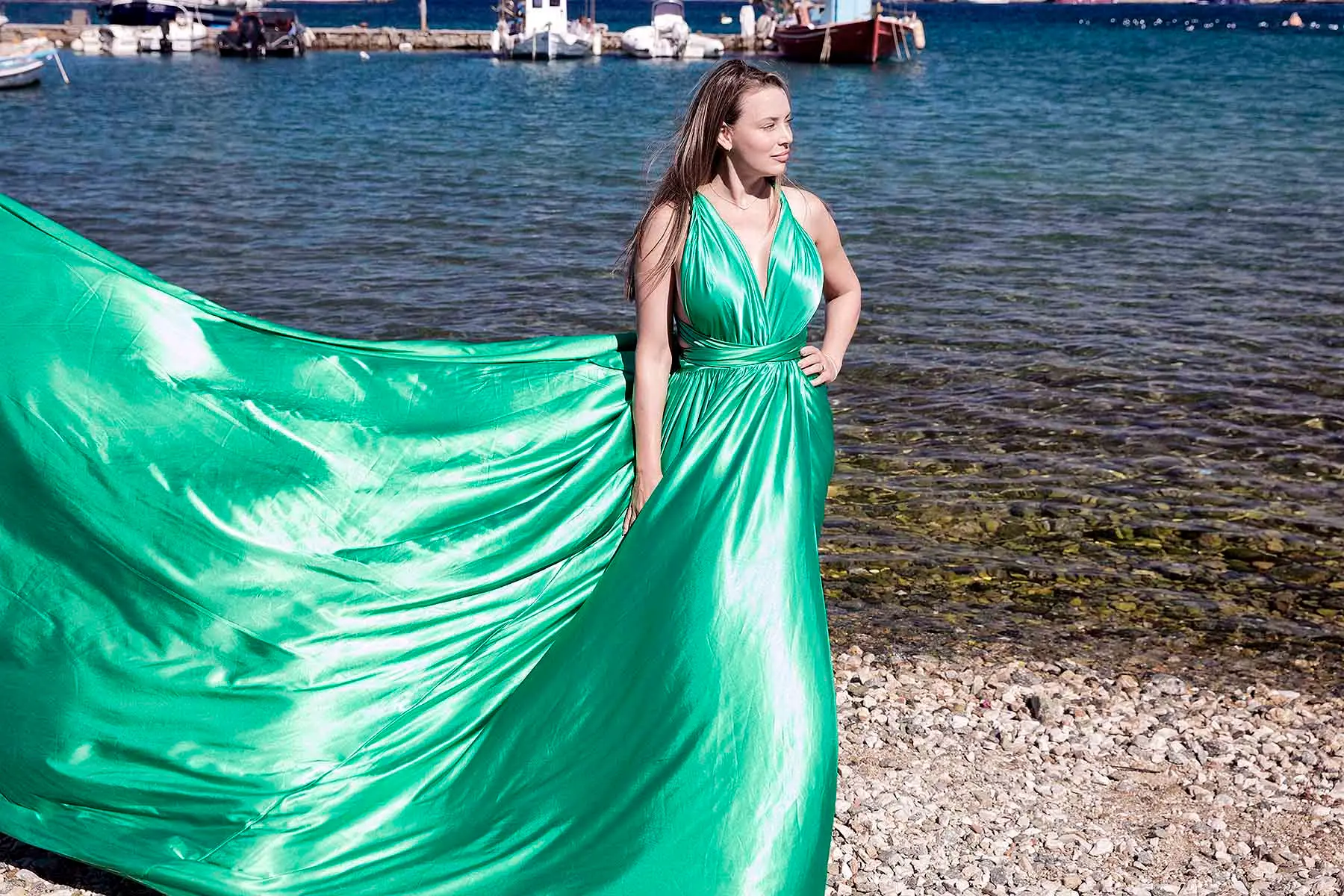 Sunlit amber flying dress by Cycladic walls, photography in Mykonos, Greece