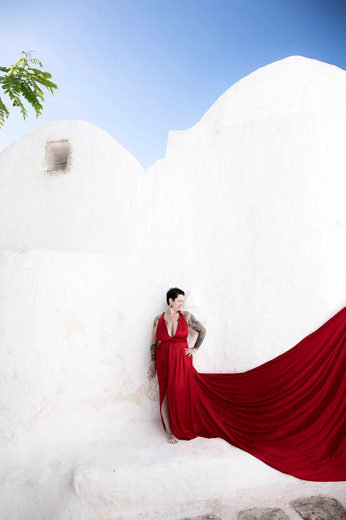 Sunlit amber flying dress on a sunlit terrace, photography in Mykonos, Greece