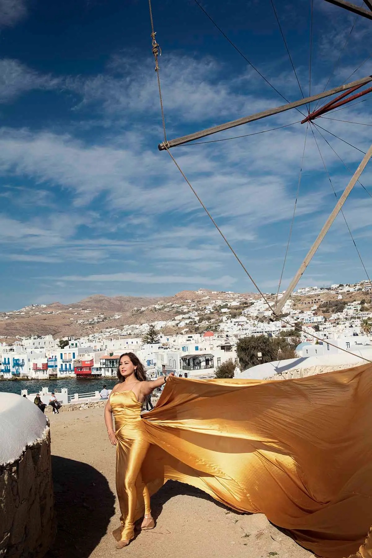 Sunlit cobalt flying dress by the Aegean sea, photography in Mykonos, Greece