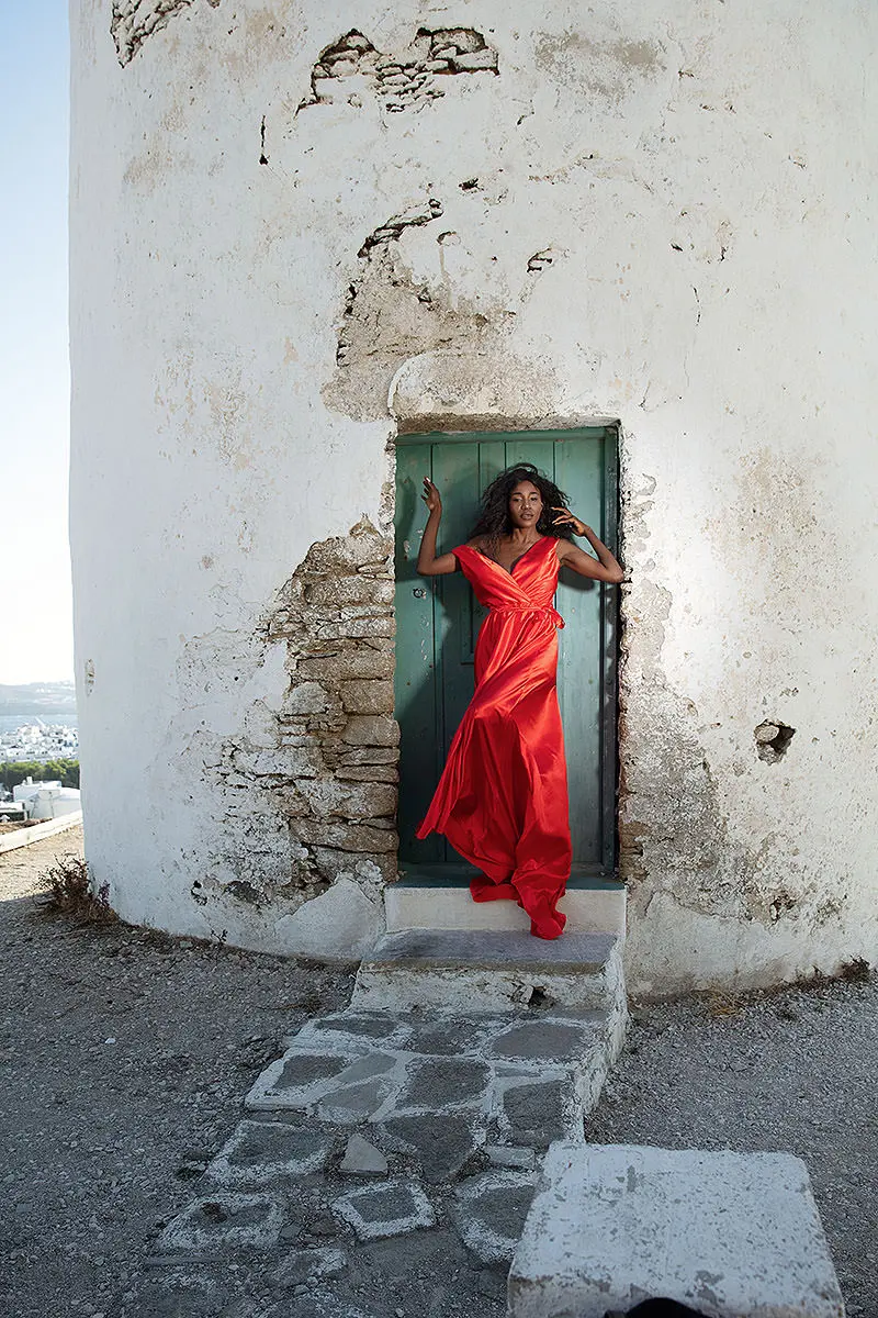 Sunlit cobalt flying dress by Cycladic walls, photography in Mykonos, Greece