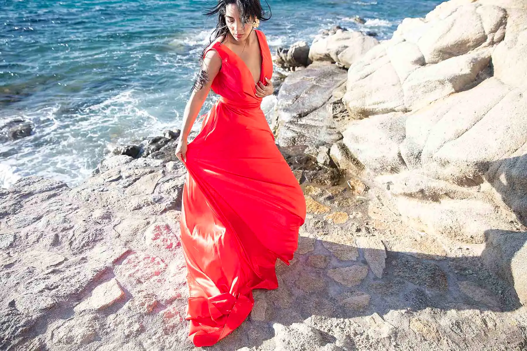 Sunlit copper flying dress in a Mykonos alley, photography in Mykonos, Greece