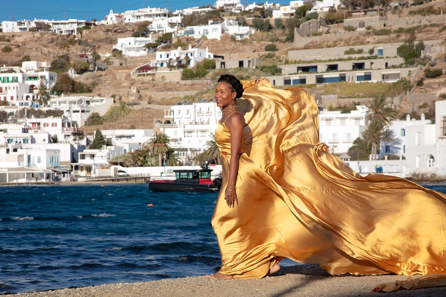 Sunlit copper flying dress on a sunlit terrace, photography in Mykonos, Greece