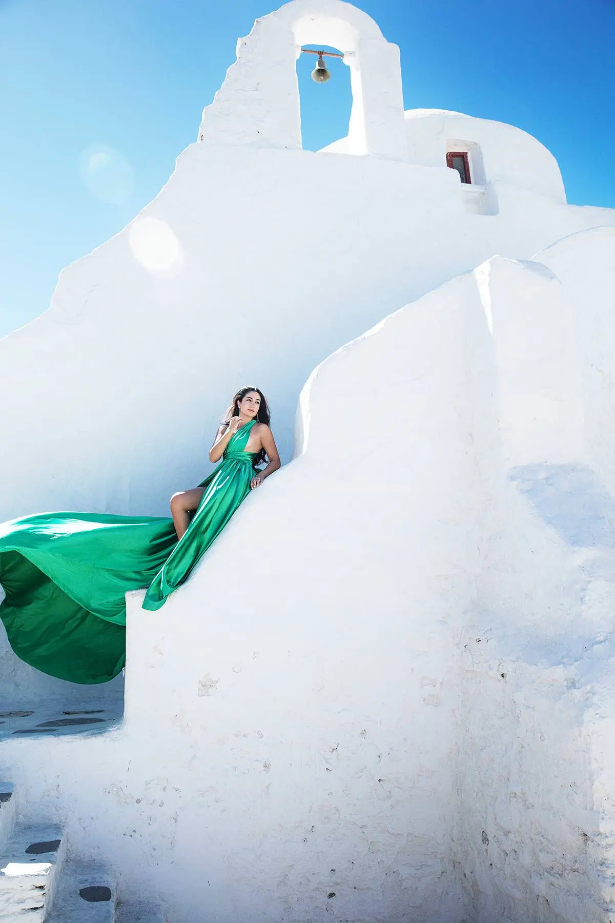 Sunlit emerald flying dress on a sunlit terrace, photography in Mykonos, Greece