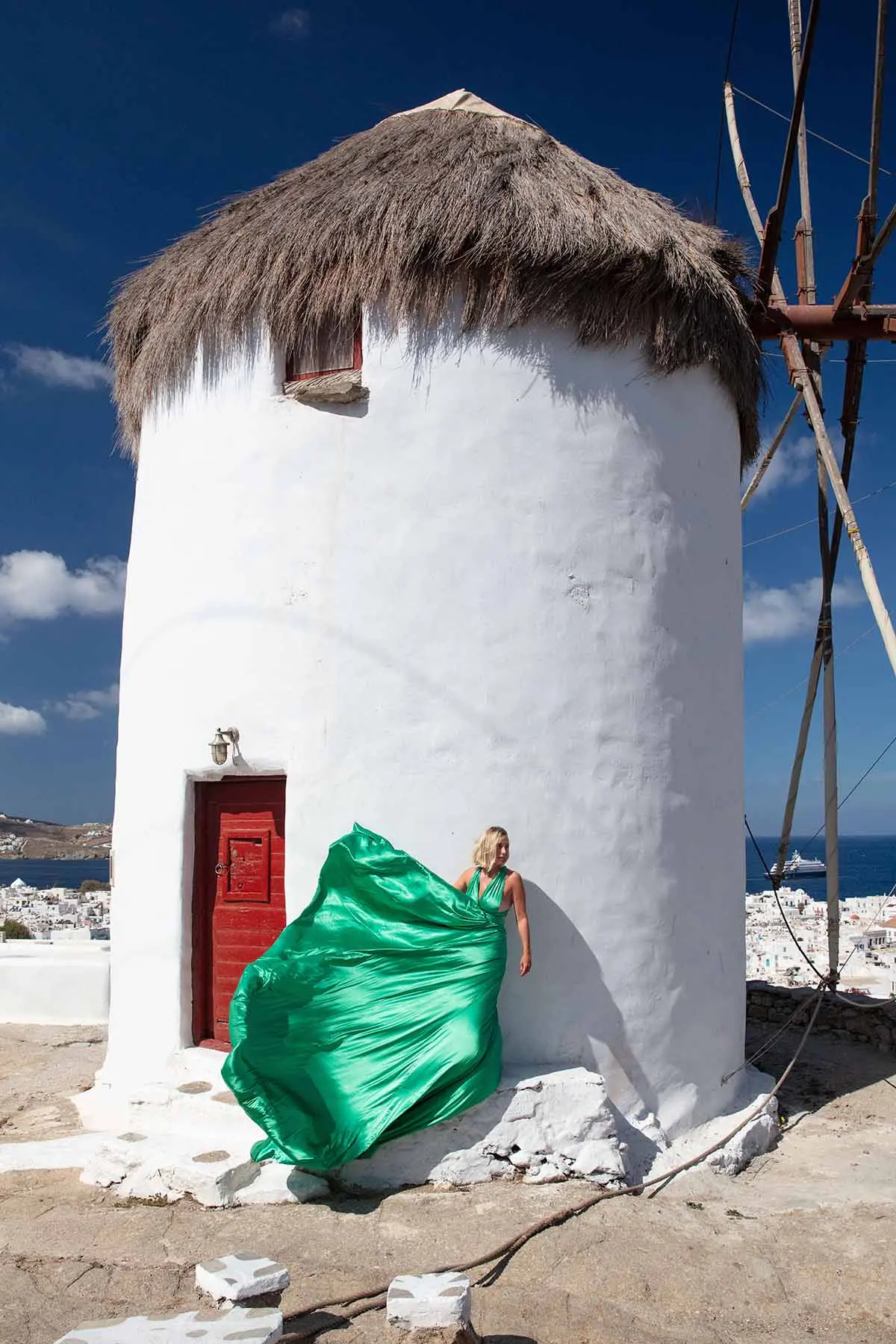 Sunlit gold flying dress on a sunlit terrace, photography in Mykonos, Greece