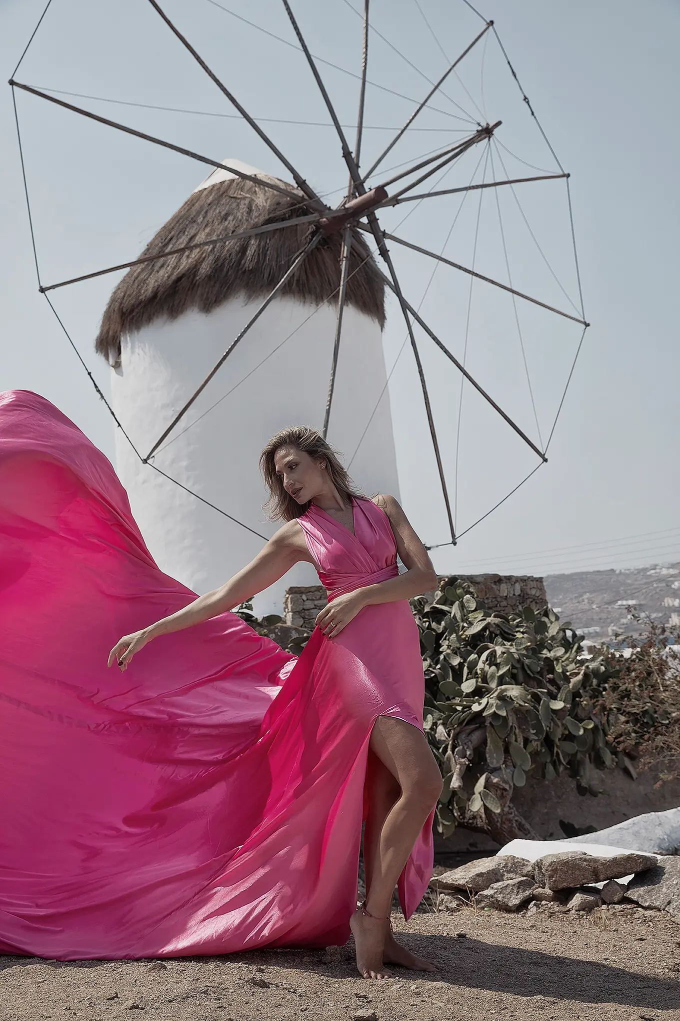 Sunlit indigo flying dress in a Mykonos alley, photography in Mykonos, Greece