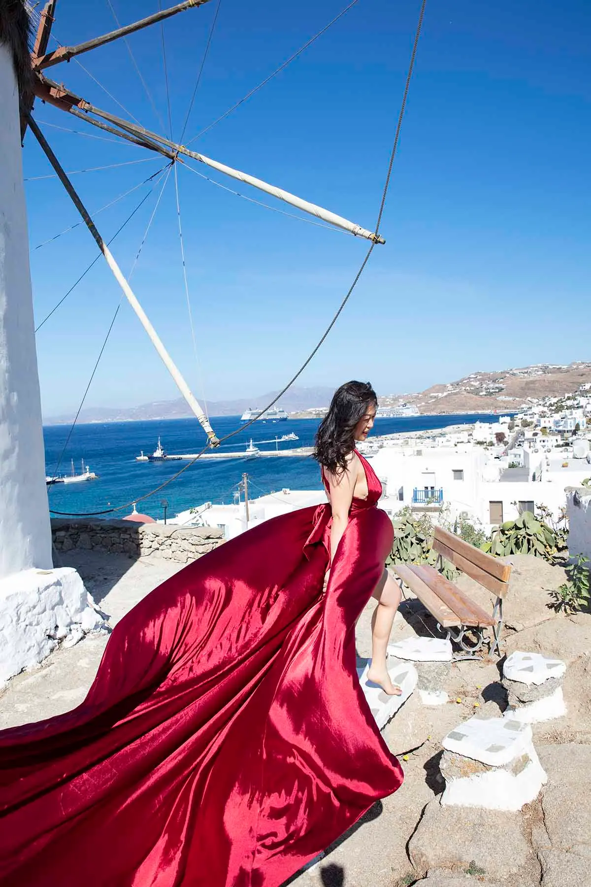 Sunlit ivory flying dress on a Mykonos rooftop, photography in Mykonos, Greece