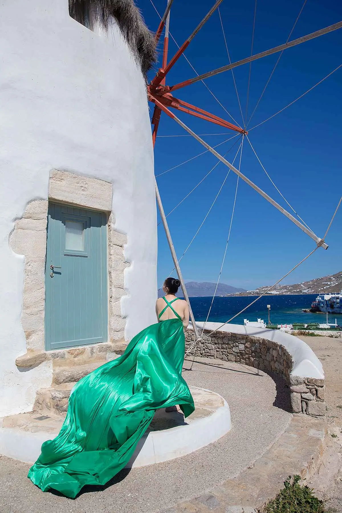 Sunlit noir alley flying dress by the Aegean sea, photography in Mykonos, Greece