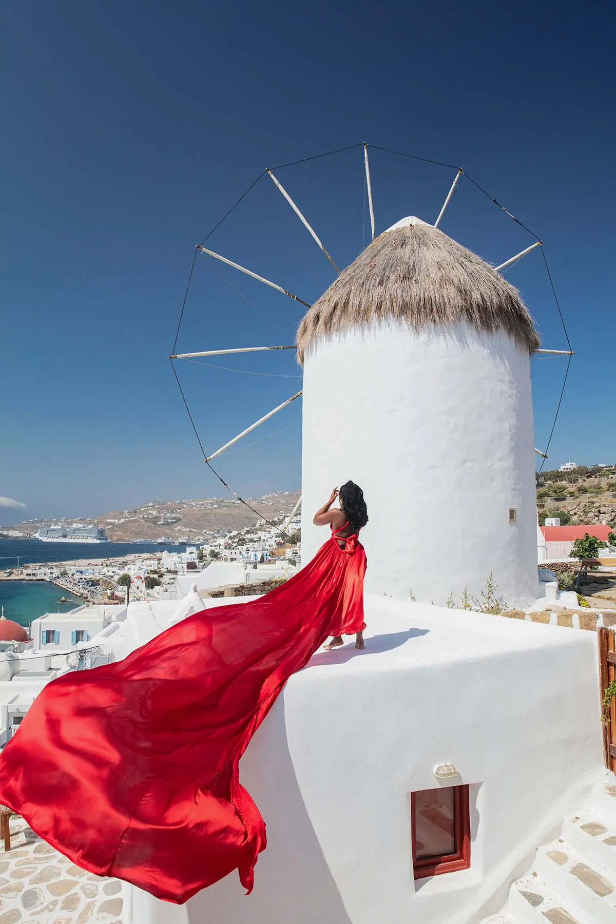 Sunlit noir alley flying dress on a sunlit terrace, photography in Mykonos, Greece