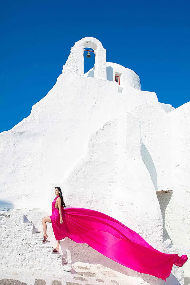 Sunlit pearl flying dress on a Mykonos rooftop, photography in Mykonos, Greece