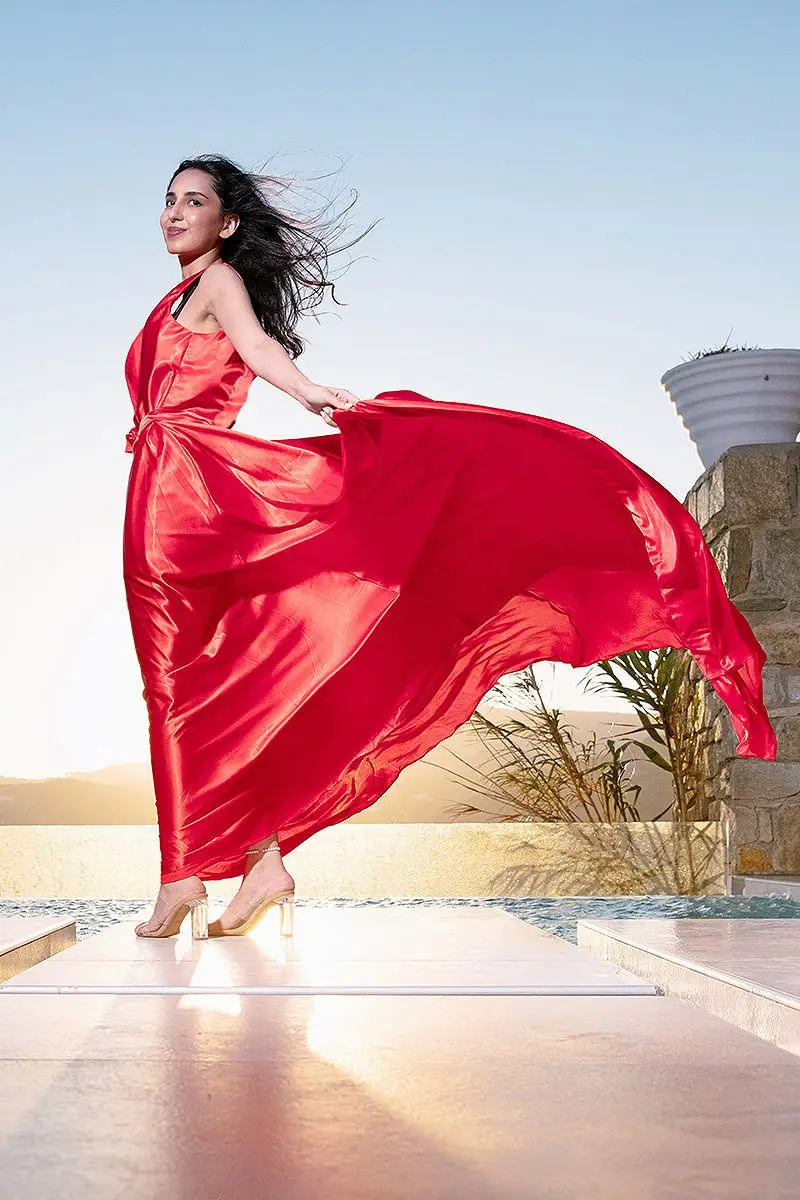 Sunlit pearl flying dress by the Aegean sea, photography in Mykonos, Greece