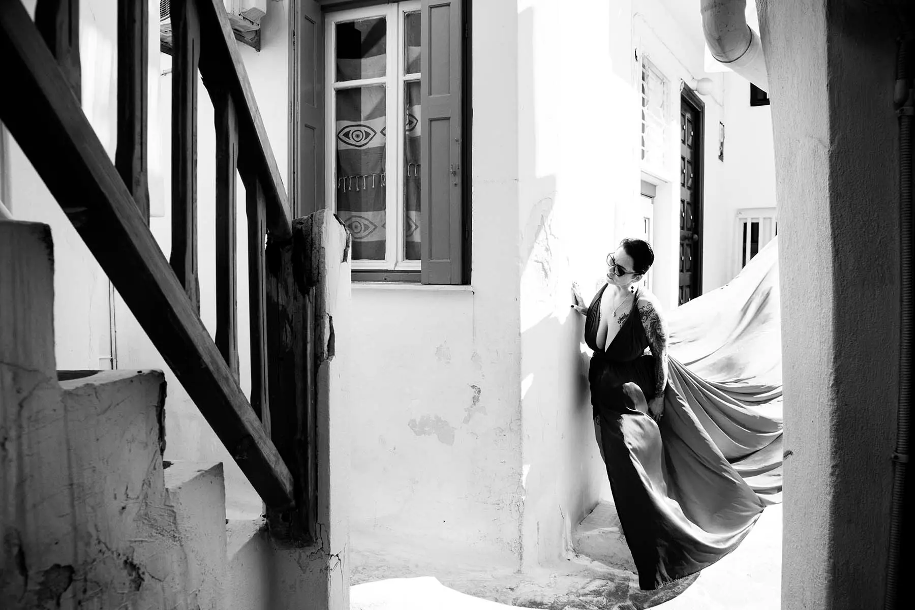 Sunlit rooftop flying dress at a Mykonos windmill, photography in Mykonos, Greece