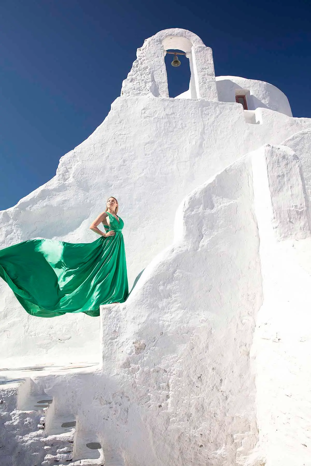 Sunlit rooftop flying dress in a Mykonos alley, photography in Mykonos, Greece