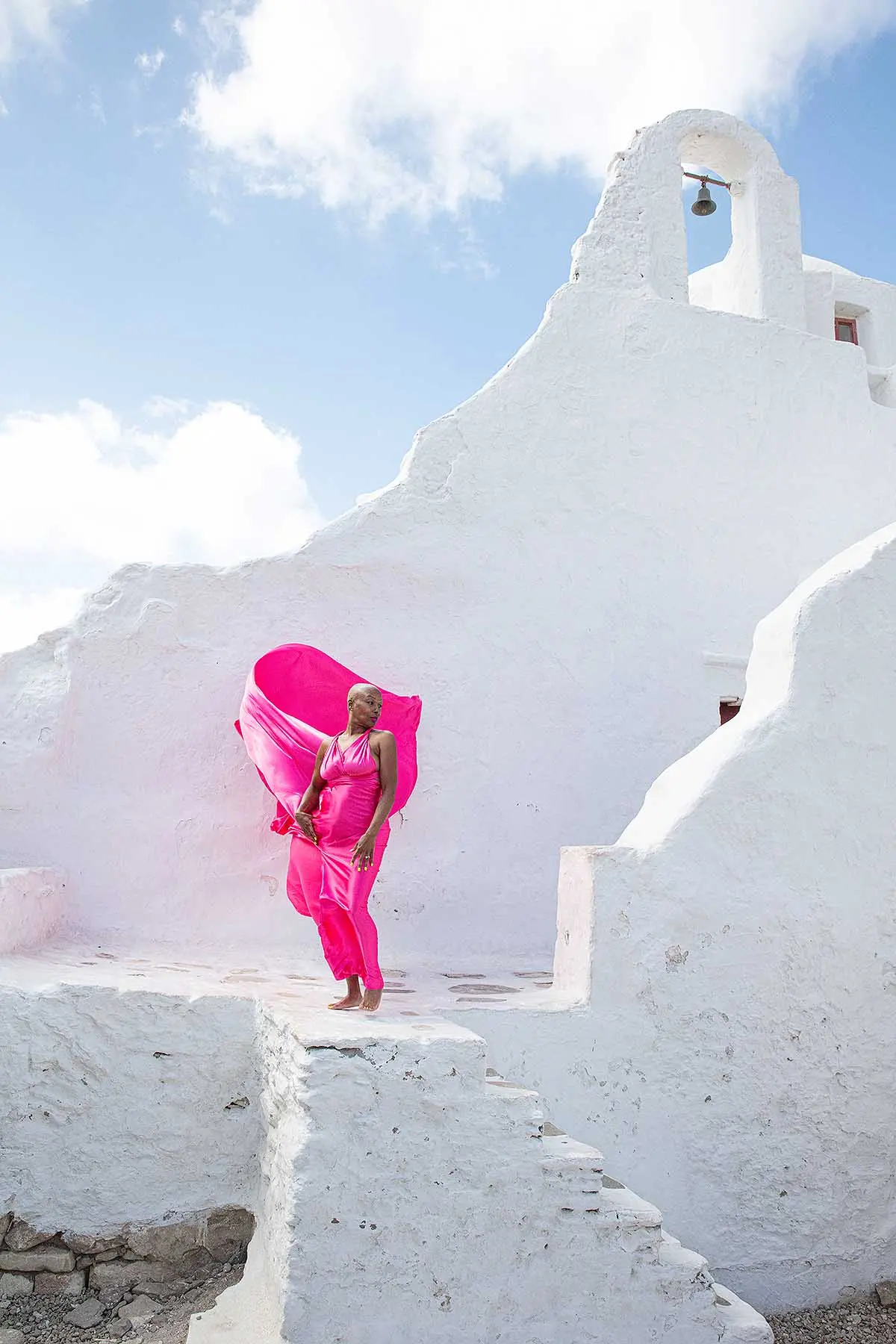 Sunlit rooftop flying dress on a Mykonos rooftop, photography in Mykonos, Greece