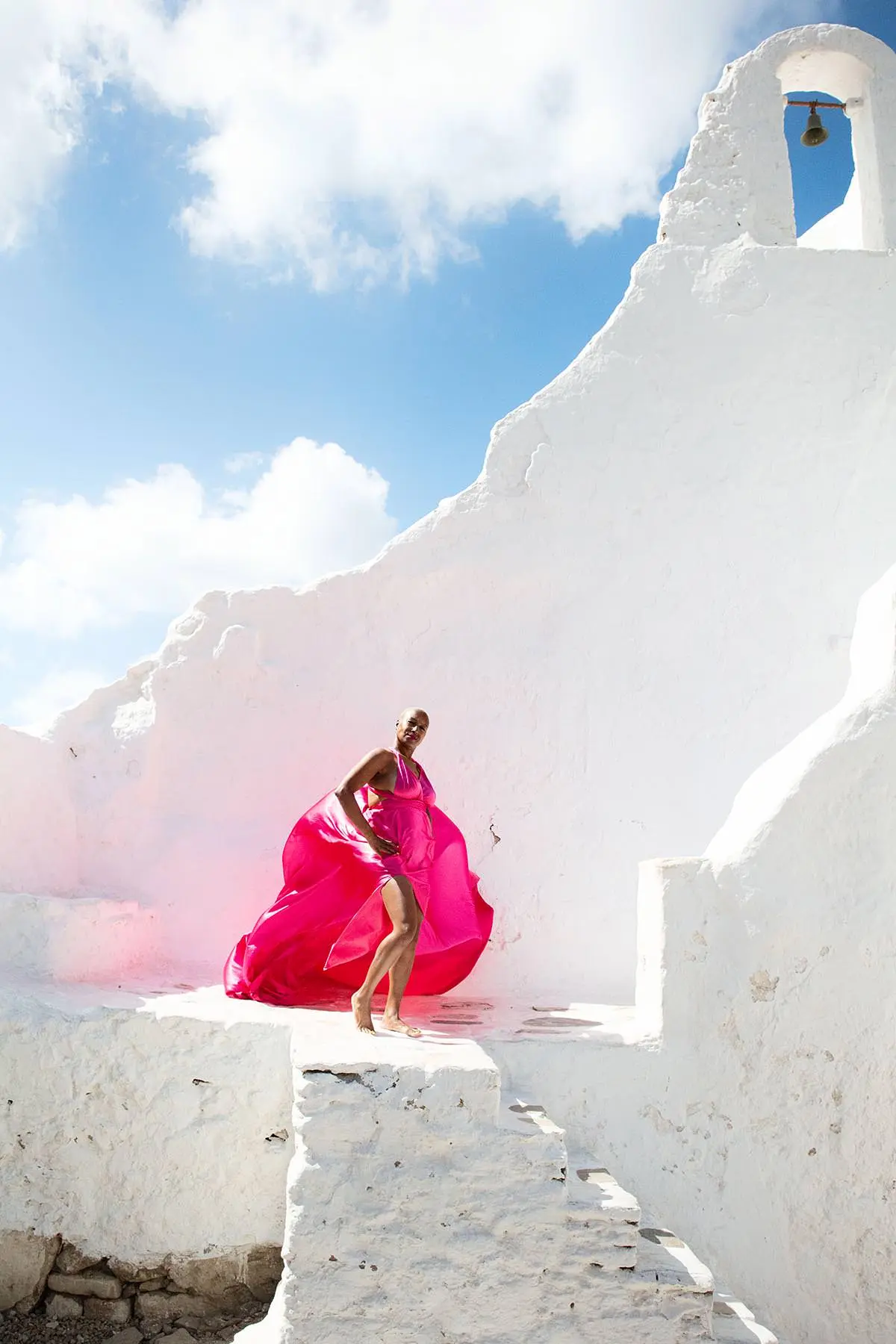 Sunlit rooftop flying dress by the Aegean sea, photography in Mykonos, Greece