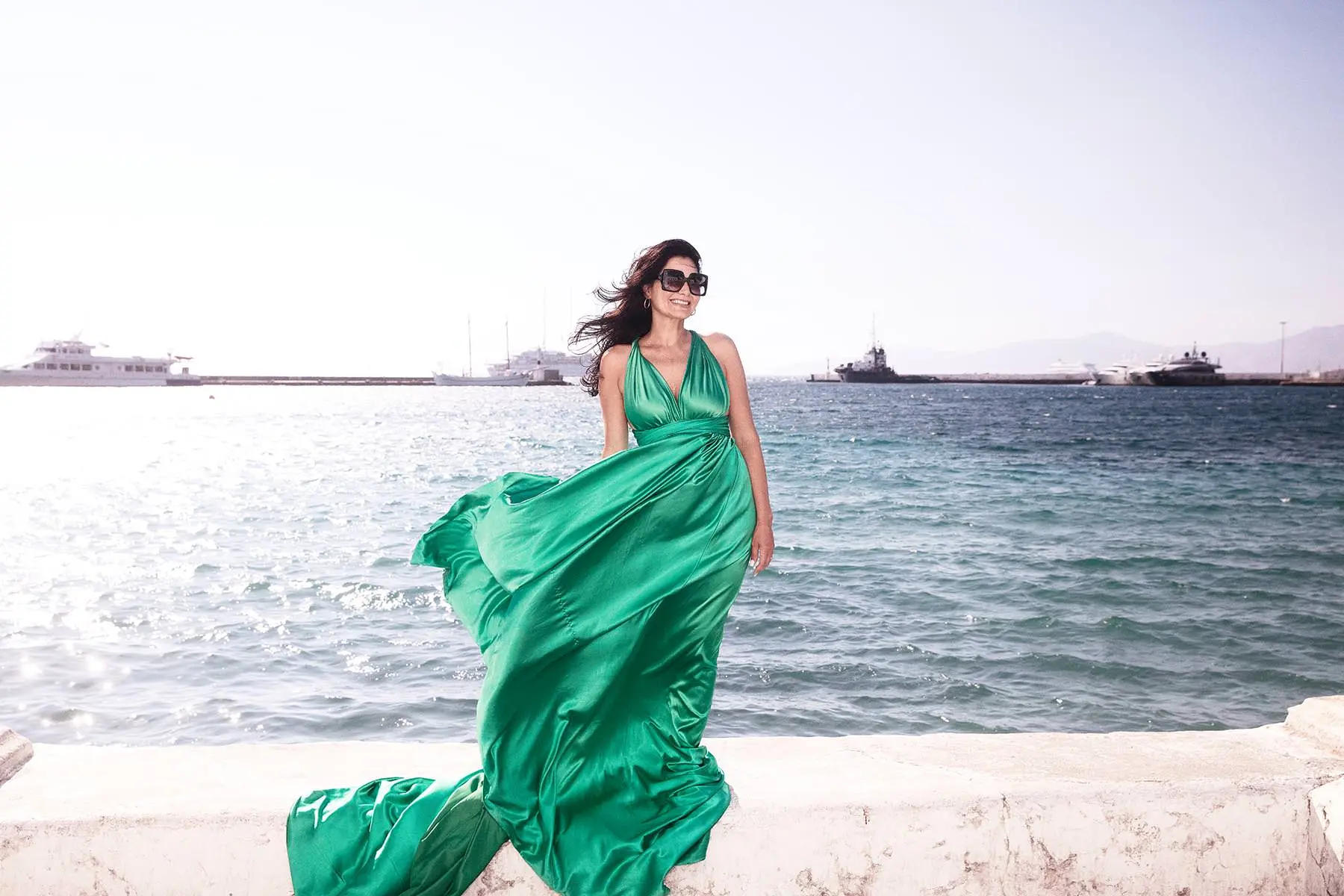 Sunlit rooftop flying dress near a whitewashed chapel, photography in Mykonos, Greece