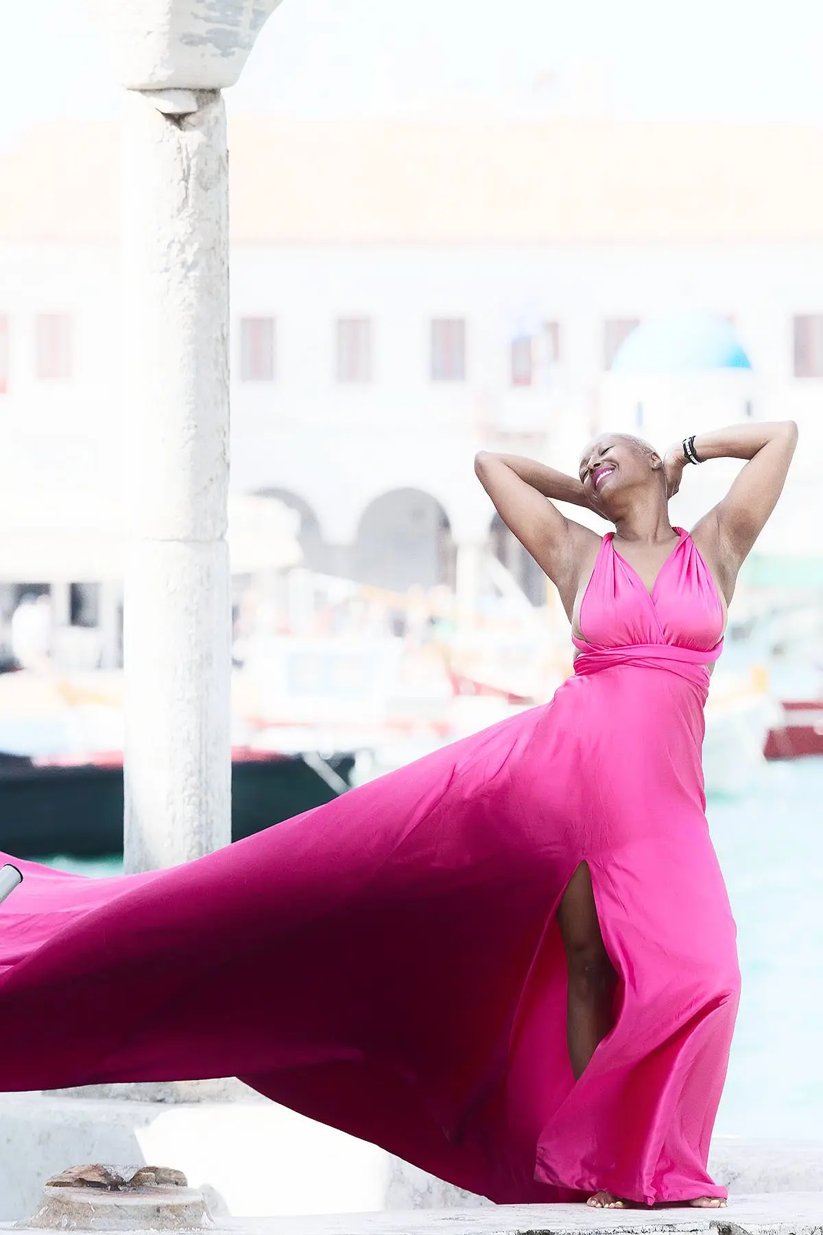 Sunlit sapphire flying dress at a Mykonos windmill, photography in Mykonos, Greece