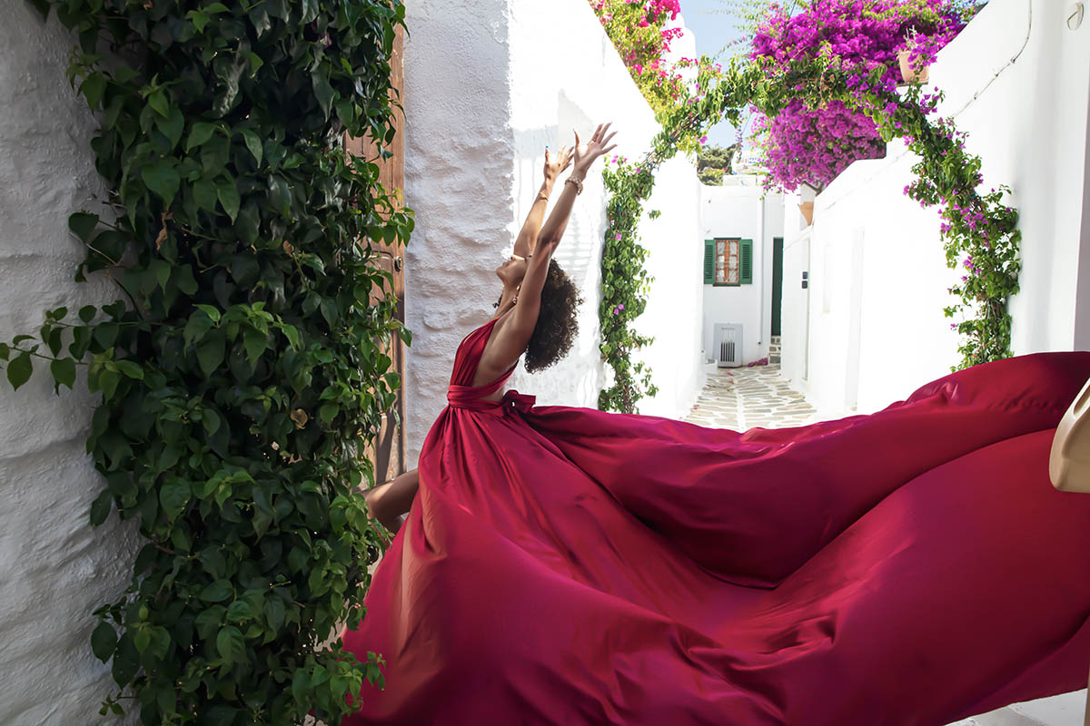 Sunlit sunset flying dress on a Mykonos rooftop, photography in Mykonos, Greece