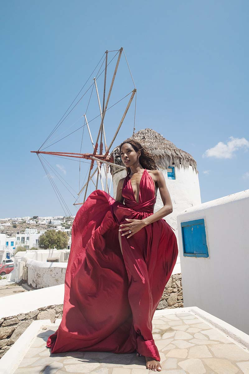 Sunlit twilight flying dress in a Mykonos alley, photography in Mykonos, Greece