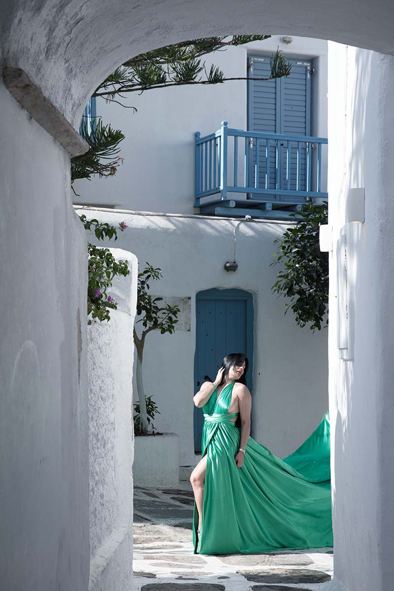 Sunlit twilight flying dress by the Aegean sea, photography in Mykonos, Greece