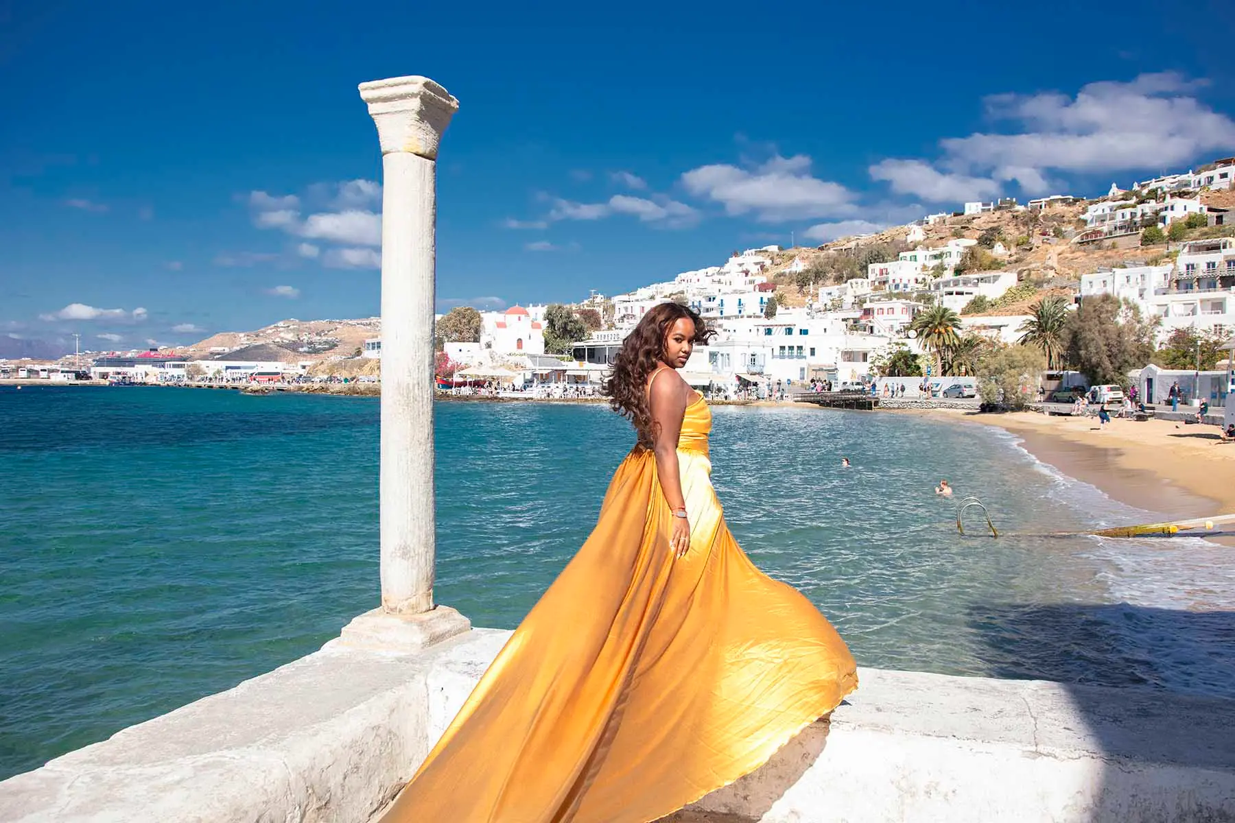 Sunlit violet flying dress on a Mykonos rooftop, photography in Mykonos, Greece