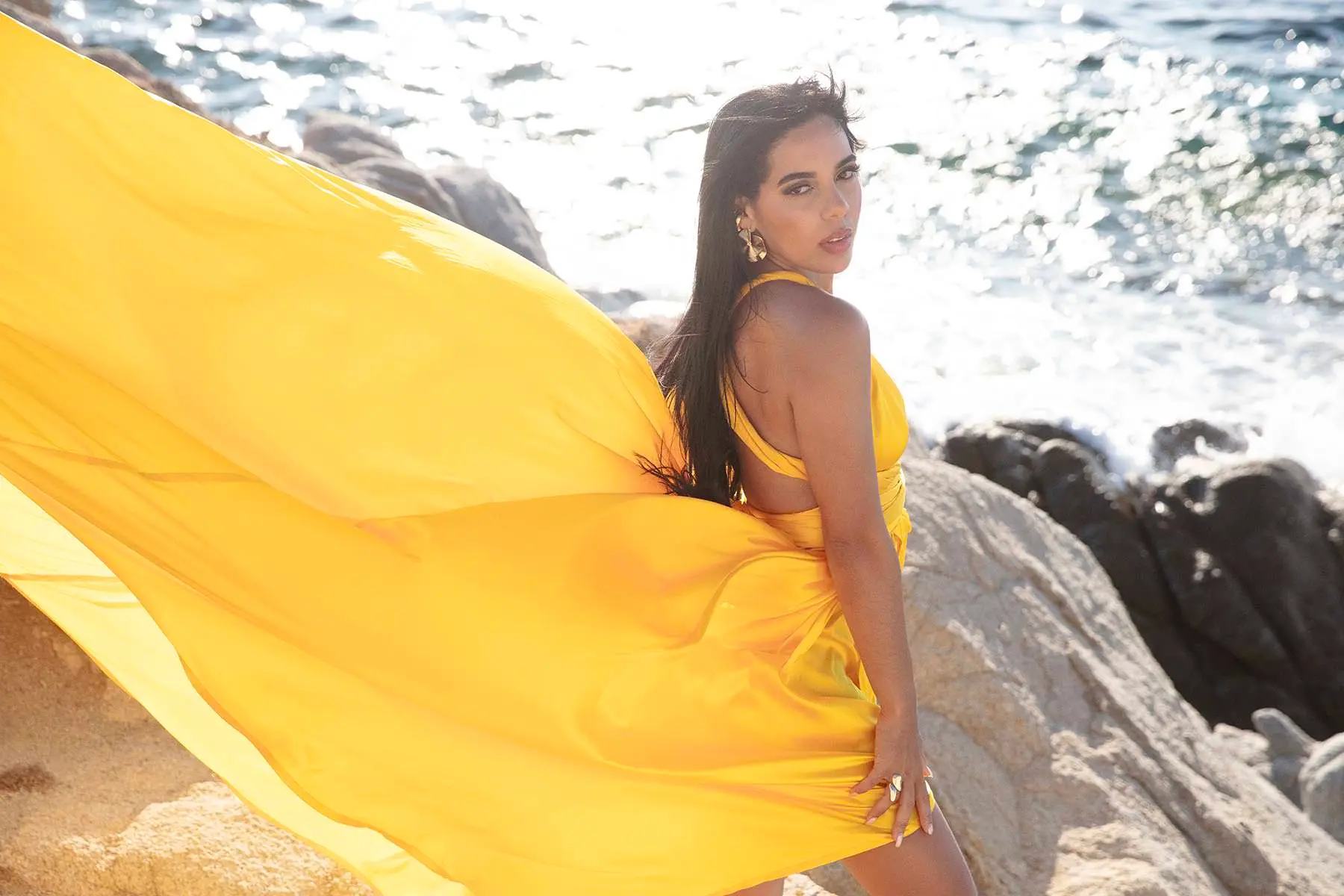 Sunlit violet flying dress by the Aegean sea, photography in Mykonos, Greece