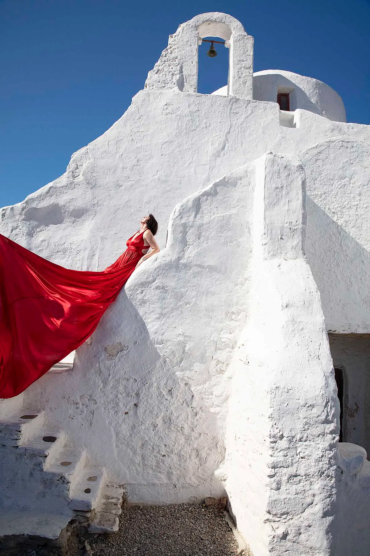 Sunlit violet flying dress on a sunlit terrace, photography in Mykonos, Greece