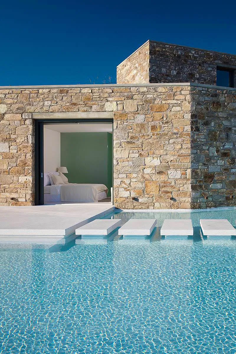 Sunlit beachfront hotels villas advertising composition in Mykonos, Greece