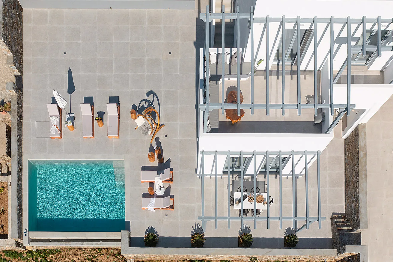 Sunlit designer villa hotels villas advertising composition in Mykonos, Greece