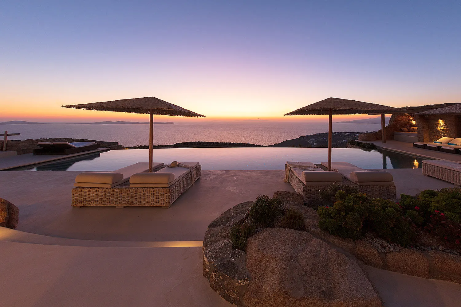 Sunlit infinity pool hotels villas advertising outtake in Mykonos, Greece