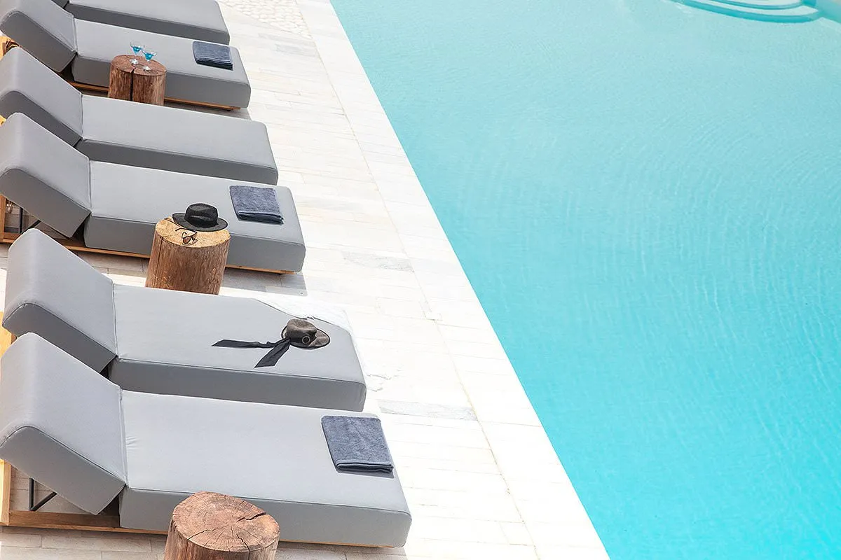 Sunlit minimalist room hotels villas advertising moment in Mykonos, Greece