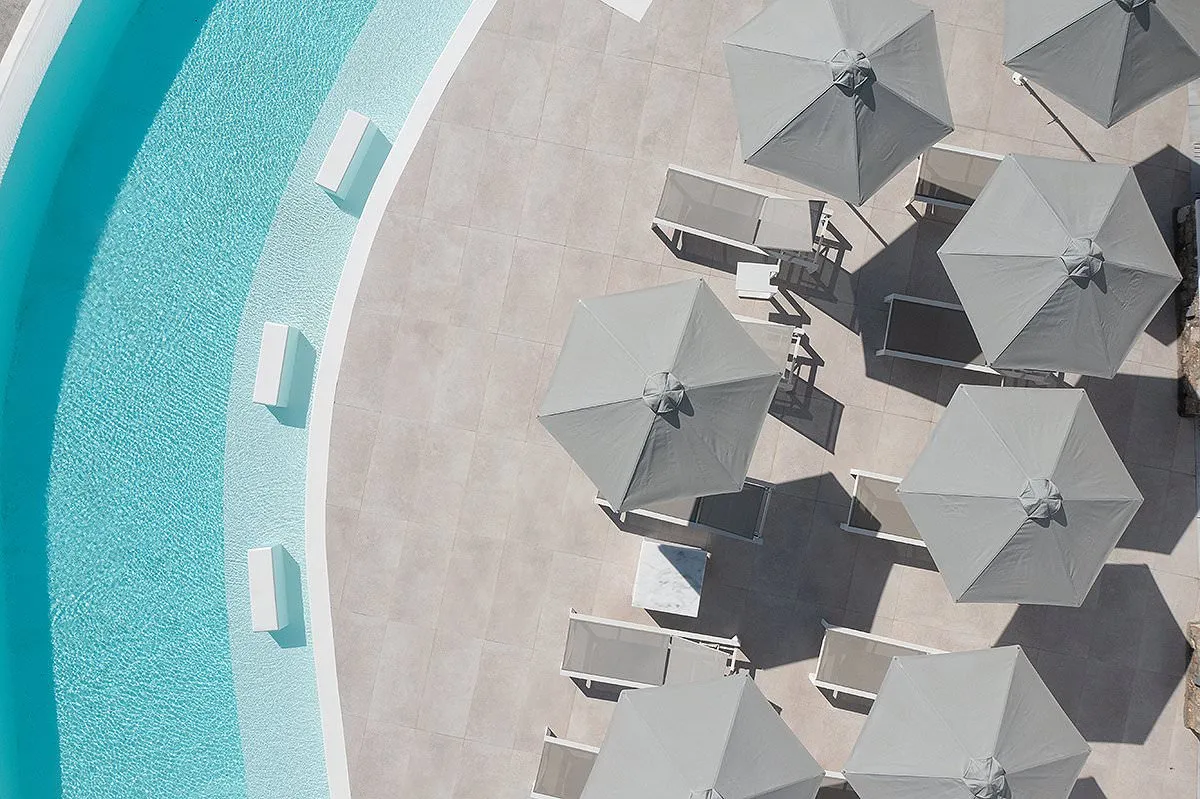 Sunlit open plan hotels villas advertising moment in Mykonos, Greece