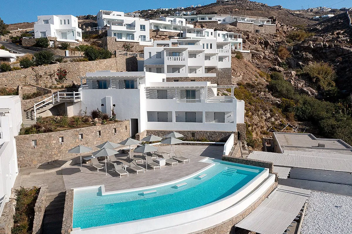 Sunlit open plan hotels villas advertising composition in Mykonos, Greece