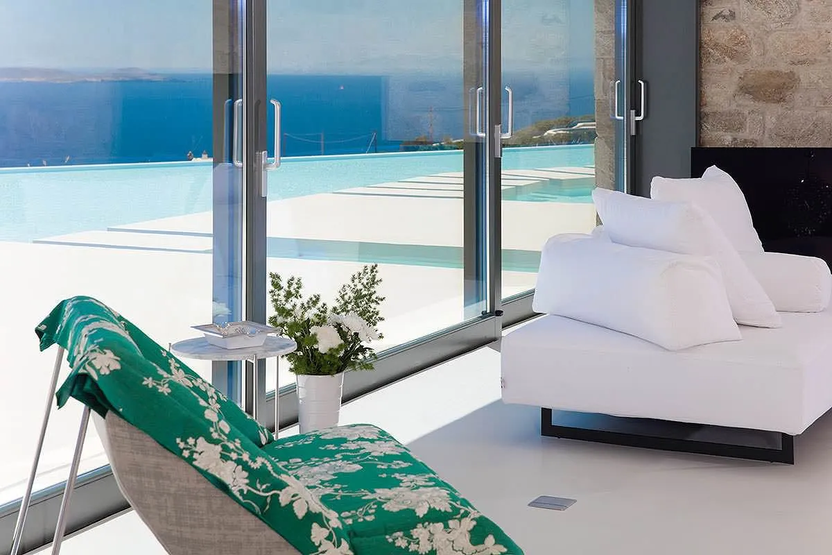 Sunlit private pool hotels villas advertising view in Mykonos, Greece